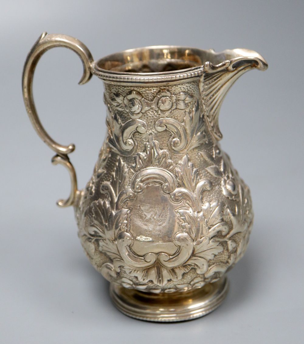 A Victorian embossed silver milk jug, Sheffield, 1860 and a silver salver, London, 1857, 27.5cm, 26oz.